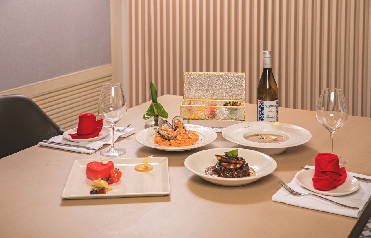 home-hero Luxurious dining setup with gourmet seafood, wine, and desserts on an elegantly dressed table.